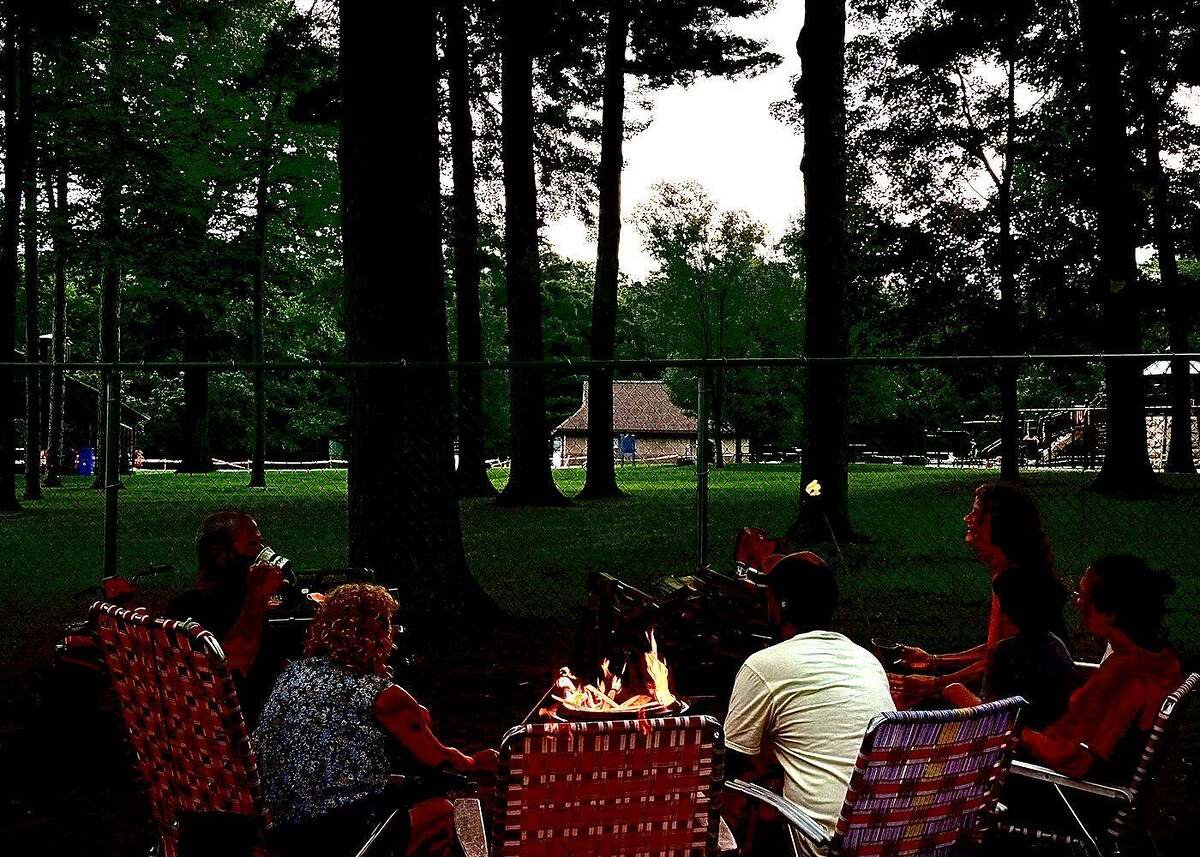 Campers around an evening campfire